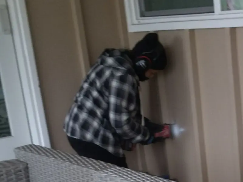 Professional electrician installing an exterior outlet in Portage